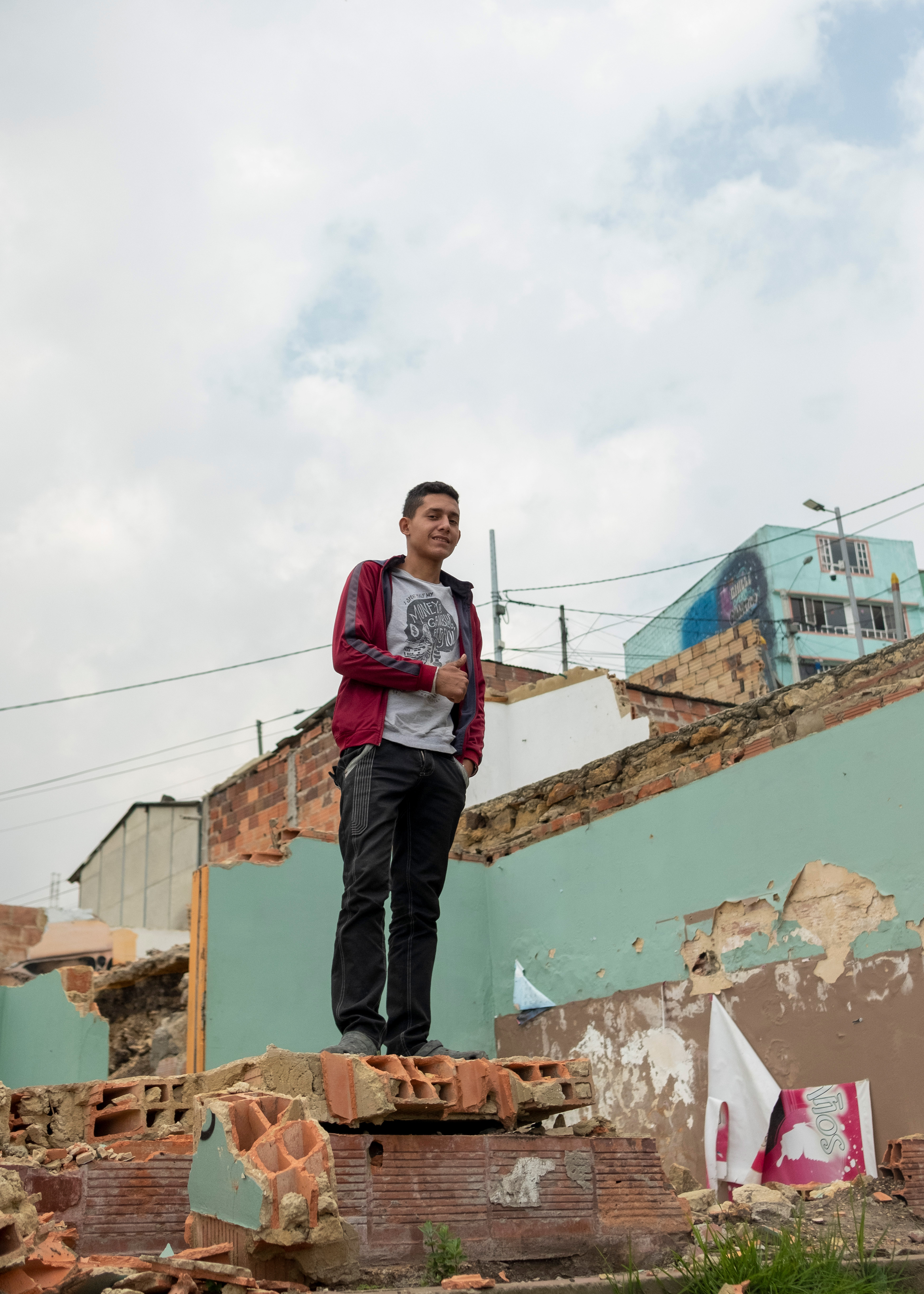 Mibzar, a 16-year-old Venezuelan migrant, stands on the foundation of a demolished home in El Paraíso.